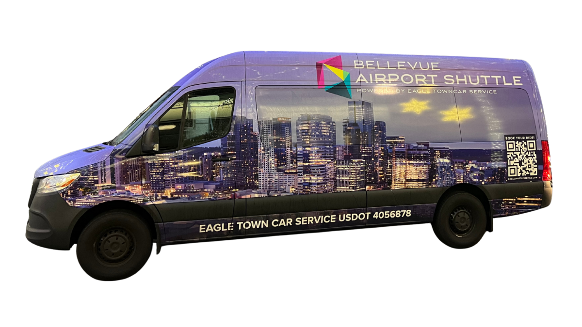 Purple van with cityscape design advertising Bellevue Airport Shuttle service.